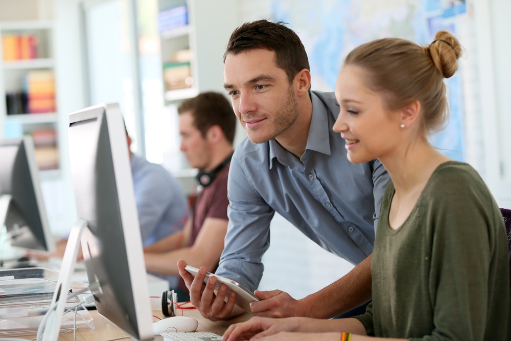 Student girl with trainer working on computer and tablet.jpeg